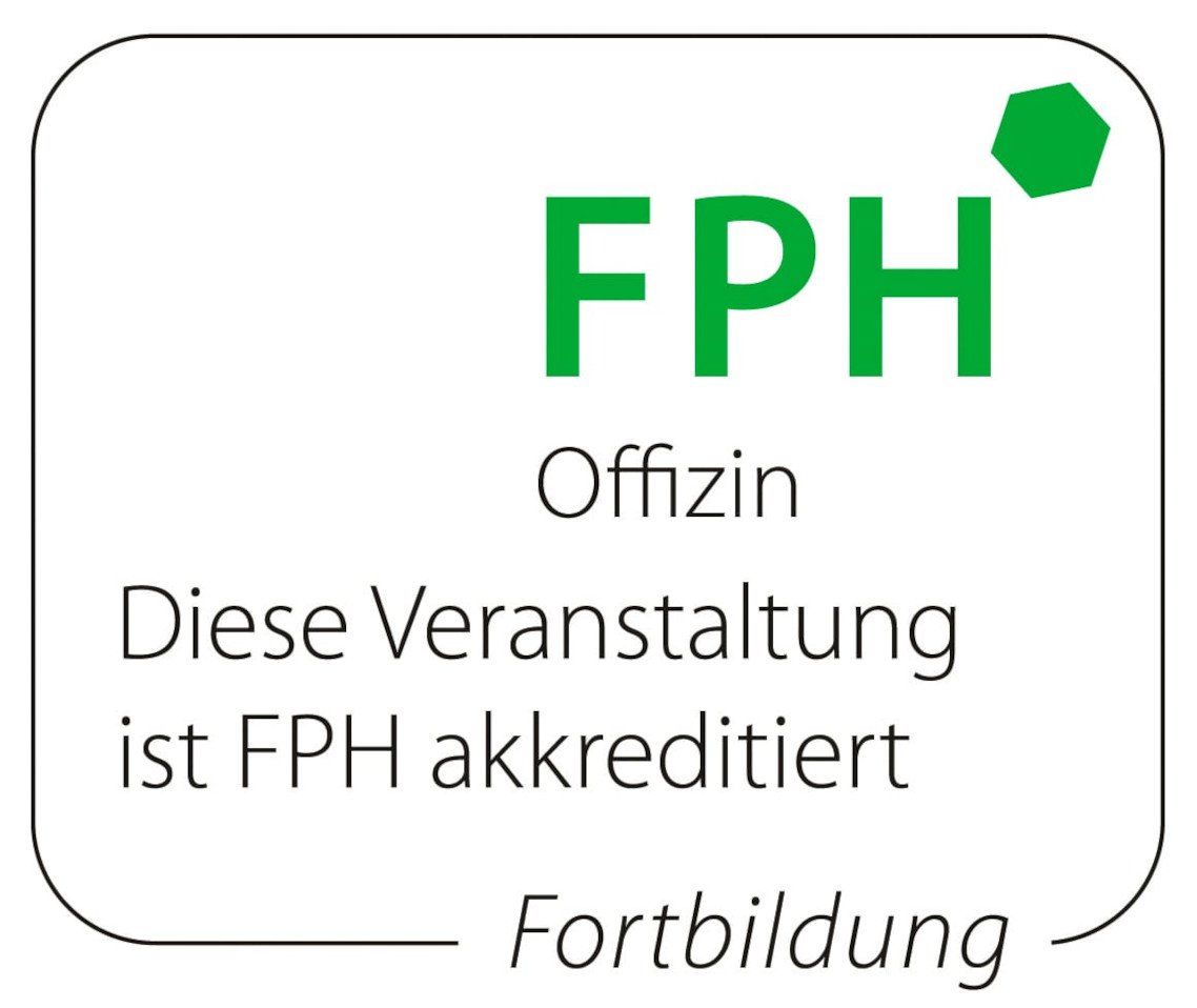 Manuela Langos sitzt lachend auf einem grauen Stuhl